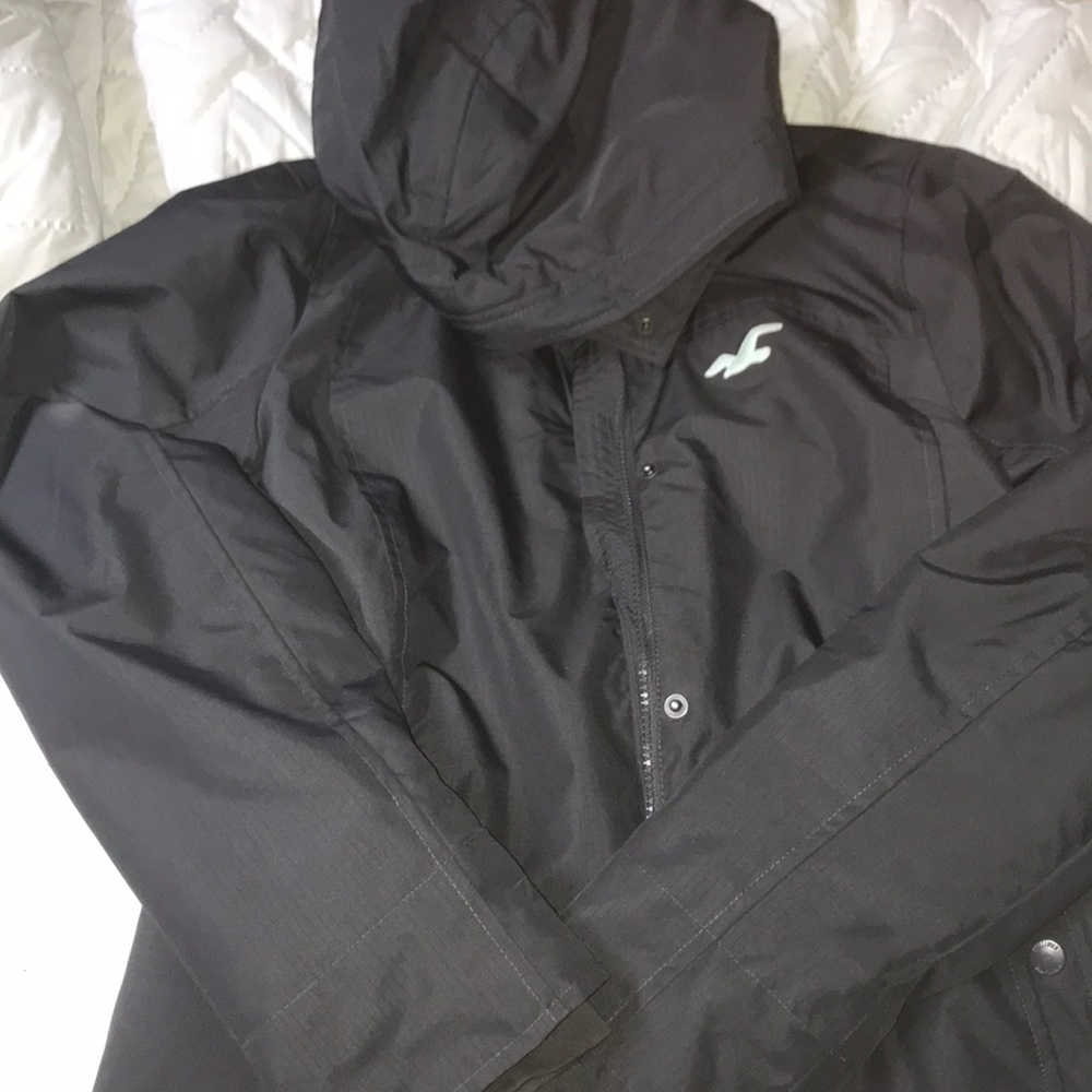 dark gray winter coat with blue details.